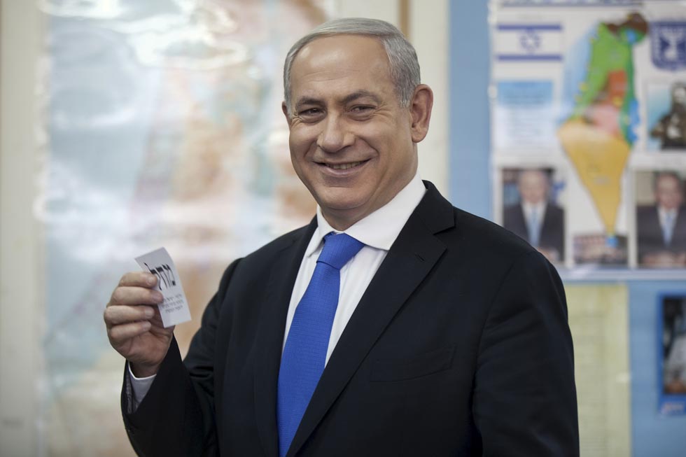 Israeli Prime Minister Benjamin Netanyahu casts his ballot†at a polling station in Jerusalem, Tuesday, Jan. 22, 2013.†Israelis headed to polling stations Tuesday to cast votes in a parliamentary election expected to return  Netanyahu to office despite years of stalled peacemaking with the Palestinians and mounting economic troubles. (AP Photo/Uriel Sinai, Pool)