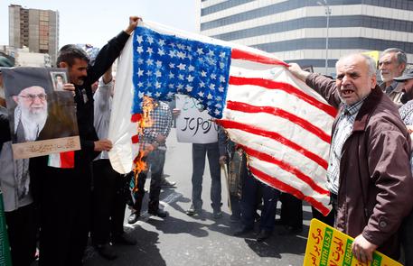 epa07560580 Demonstrators burn a US flag during an anti-US rally, to show their support of Iran's decision to pull out from some part of nuclear deal, in Tehran, Iran, 10 May 2019. Media reported that on 08 May 2019 that President Hassan Rouhani announced Iran's decision to pull out from part of a 2015 international nuclear deal, a year after US President Trump pulled out of the agreement. The move was formally conveyed to ambassadors to countries remaining inside the deal (Germany, France, Russia, Britain and China).  EPA/ABEDIN TAHERKENAREH